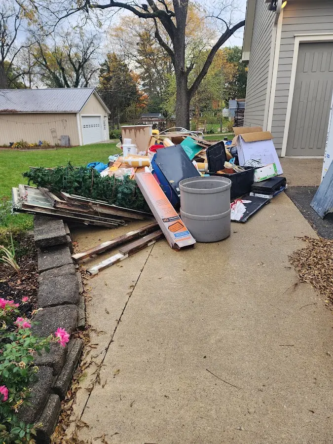 Dumpster being loaded with debris for Estate Cleanout Dumpster Rental in Naples